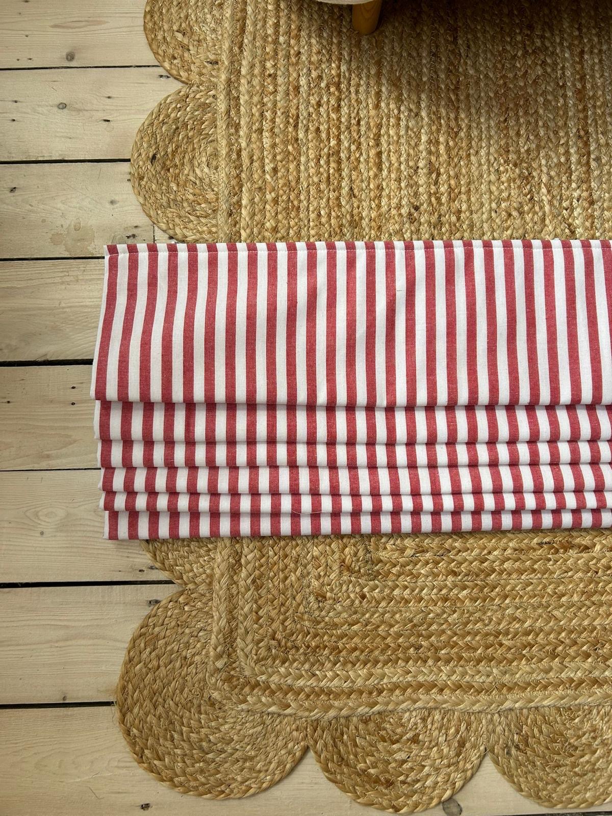A finished Roman blind in red and white striped cotton