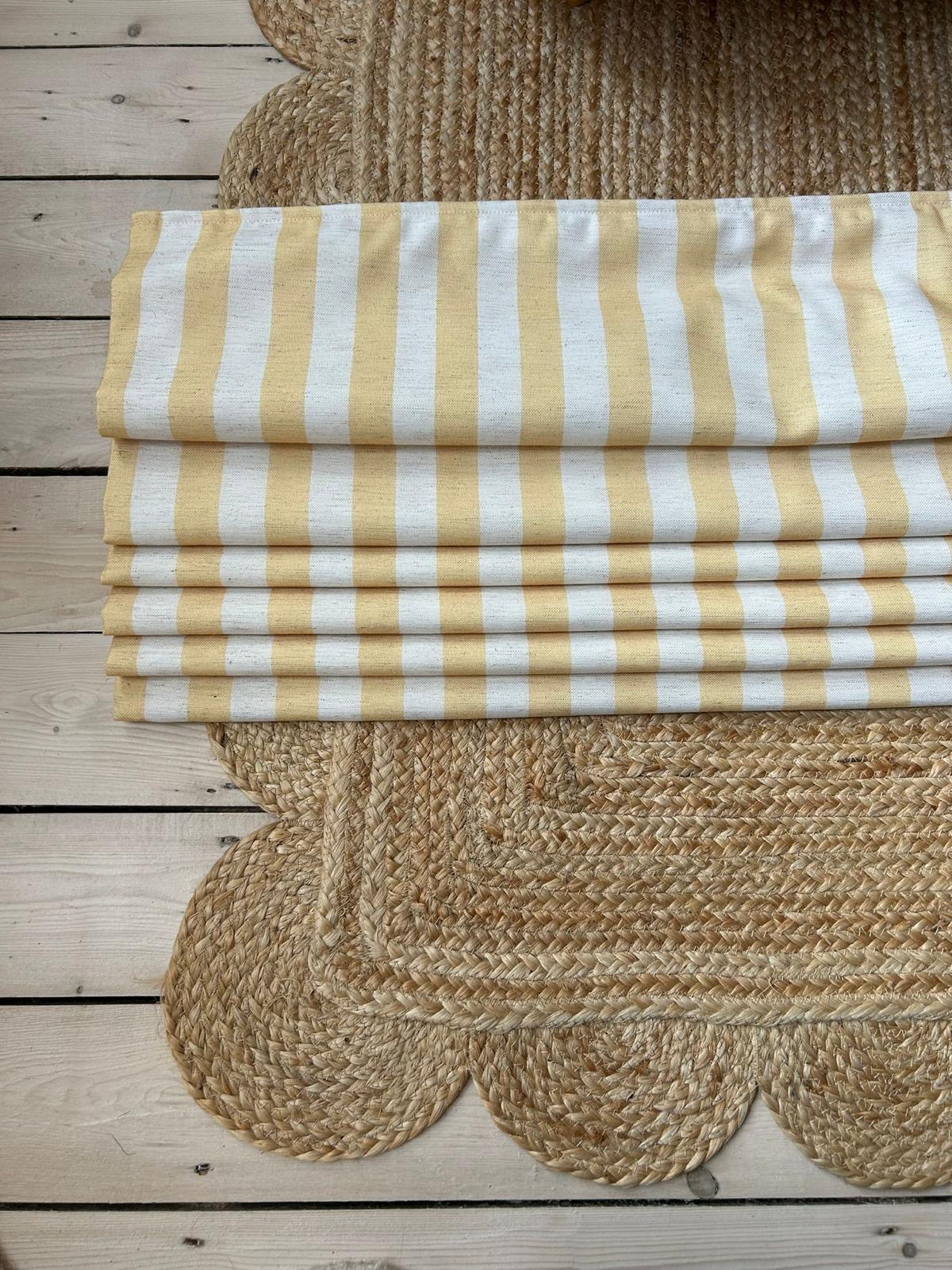 A finished Roman blind in buttercup yellow and white stripe fabric
